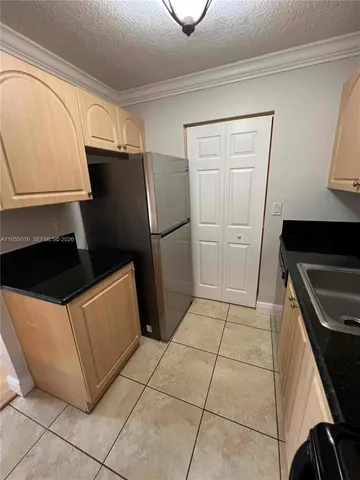 a kitchen with stainless steel appliances a refrigerator and a stove