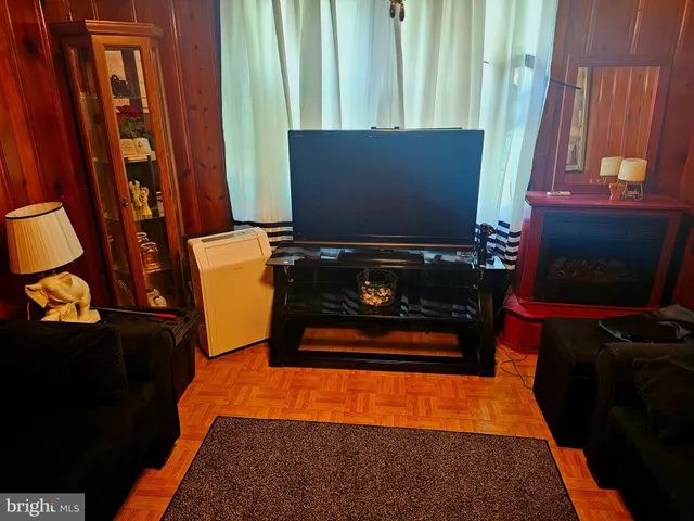 a view of a door and chair in wooden floor