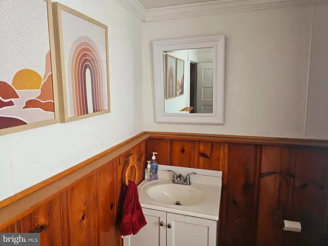 a view of a livingroom with wooden floor and stairs