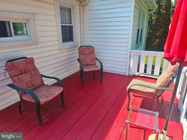 a view of a patio with a table chairs and backyard