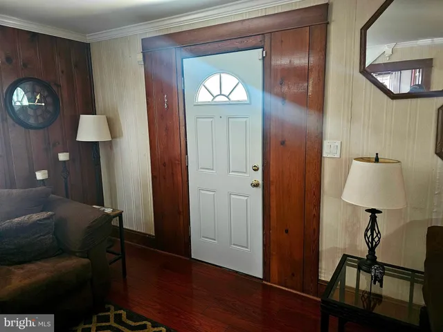 a living room with furniture and a lamp