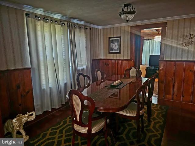 a view of a dining room with furniture and window