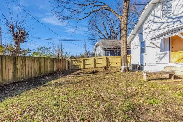 a view of a backyard with wooden fence