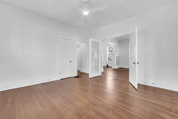 a view of empty room with wooden floor