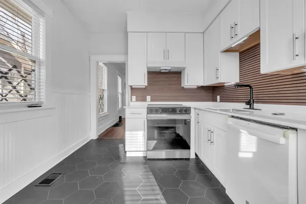 a kitchen with stainless steel appliances granite countertop a sink and a stove
