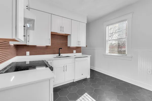 a kitchen that has a sink and a stove