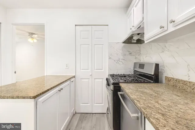 a kitchen with stainless steel appliances granite countertop a stove and a sink