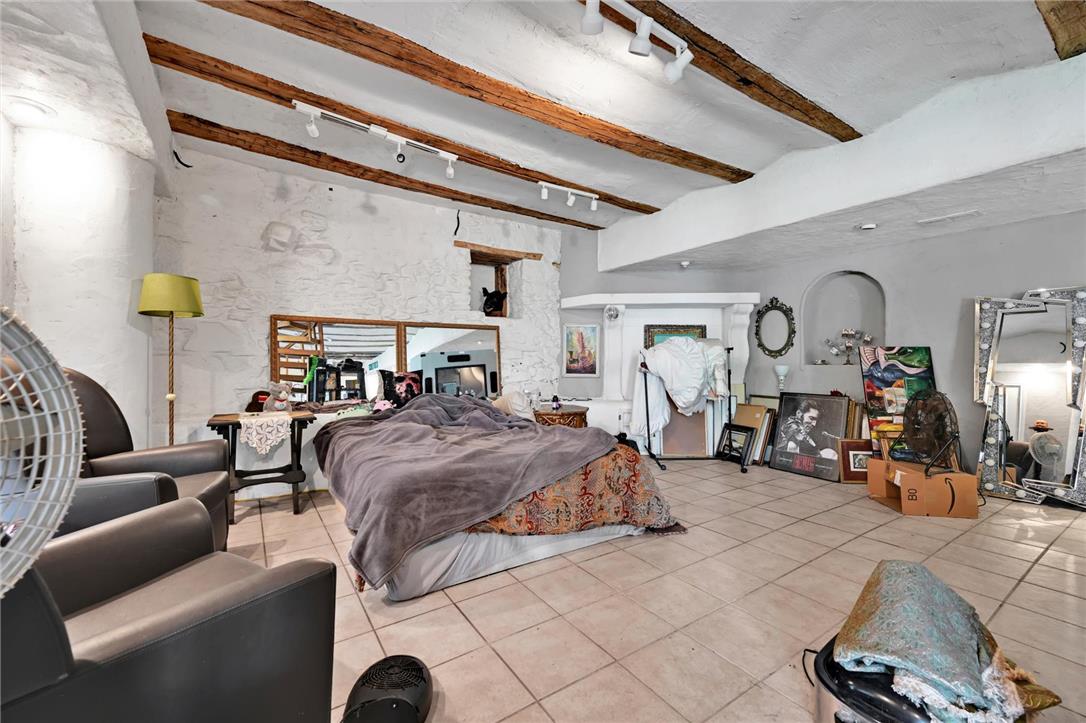 101 Conrad Road Fleetwood, PA 19522 - Photo 17 of 42 Exposed wood beams and tiled floors highlight this generously sized bedroom space.