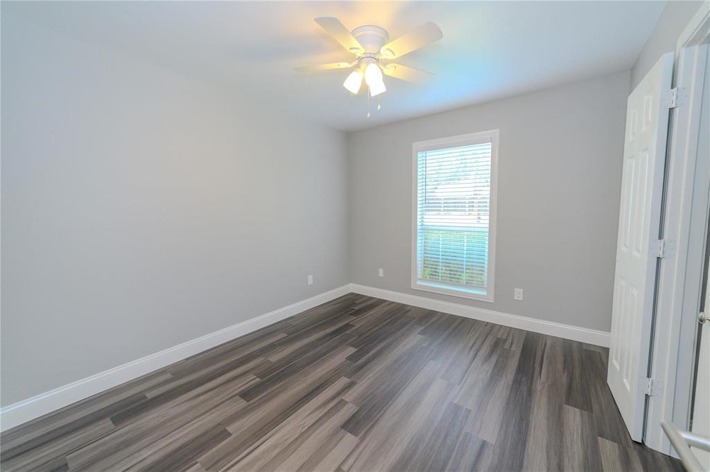 809 Wilcox Street McKinney, TX 75069 - Photo 17 of 26 Unfurnished bedroom featuring dark wood-style floors and ceiling fan