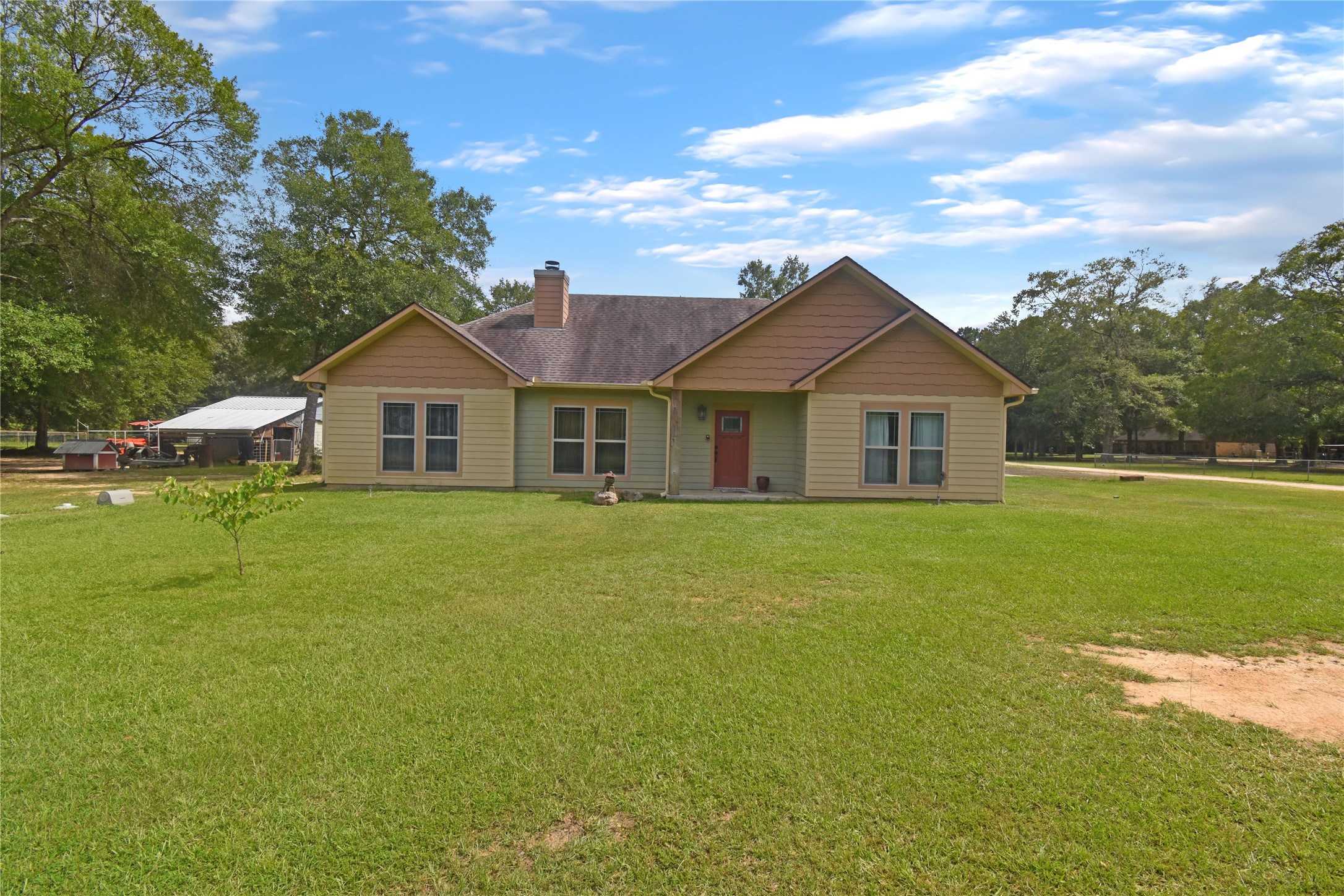 a front view of a house with a garden