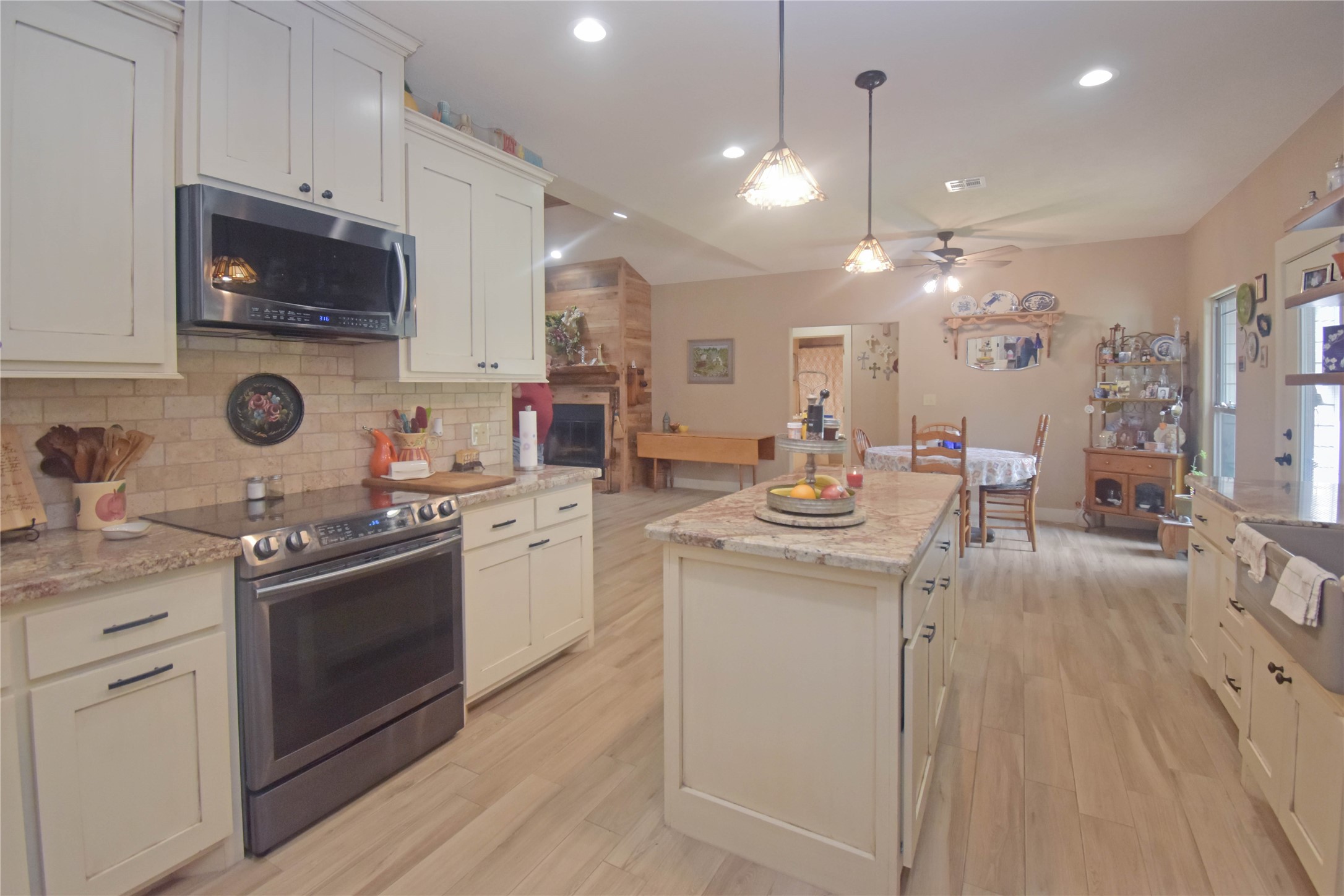 115 Pr 5250 Warren, TX 77664 - Photo 6 of 21 a kitchen with kitchen island granite countertop a sink appliances cabinets and a counter top space