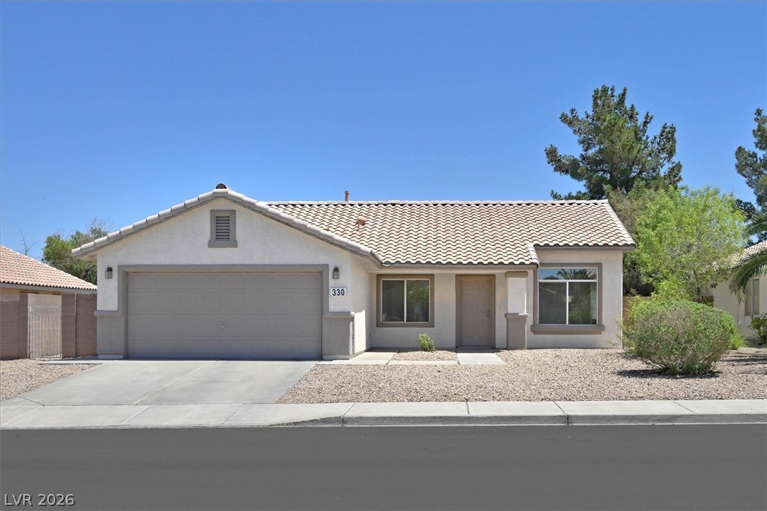 This charming home offers a single-story design with an attached garage and a welcoming facade.