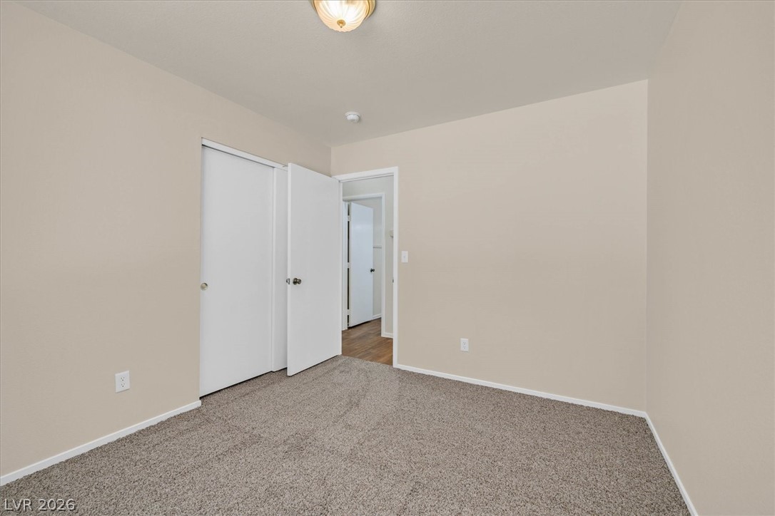 330 Warm Front Street Henderson, NV 89014 - Photo 14 of 25 This cozy bedroom offers a tranquil retreat with soft carpeting and natural light.