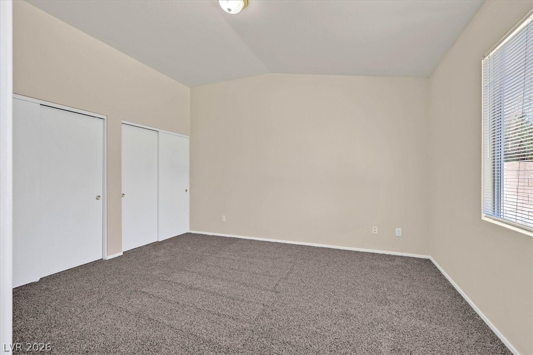330 Warm Front Street Henderson, NV 89014 - Photo 15 of 25 This spacious bedroom offers ample storage with convenient sliding closet doors and abundant natural light.