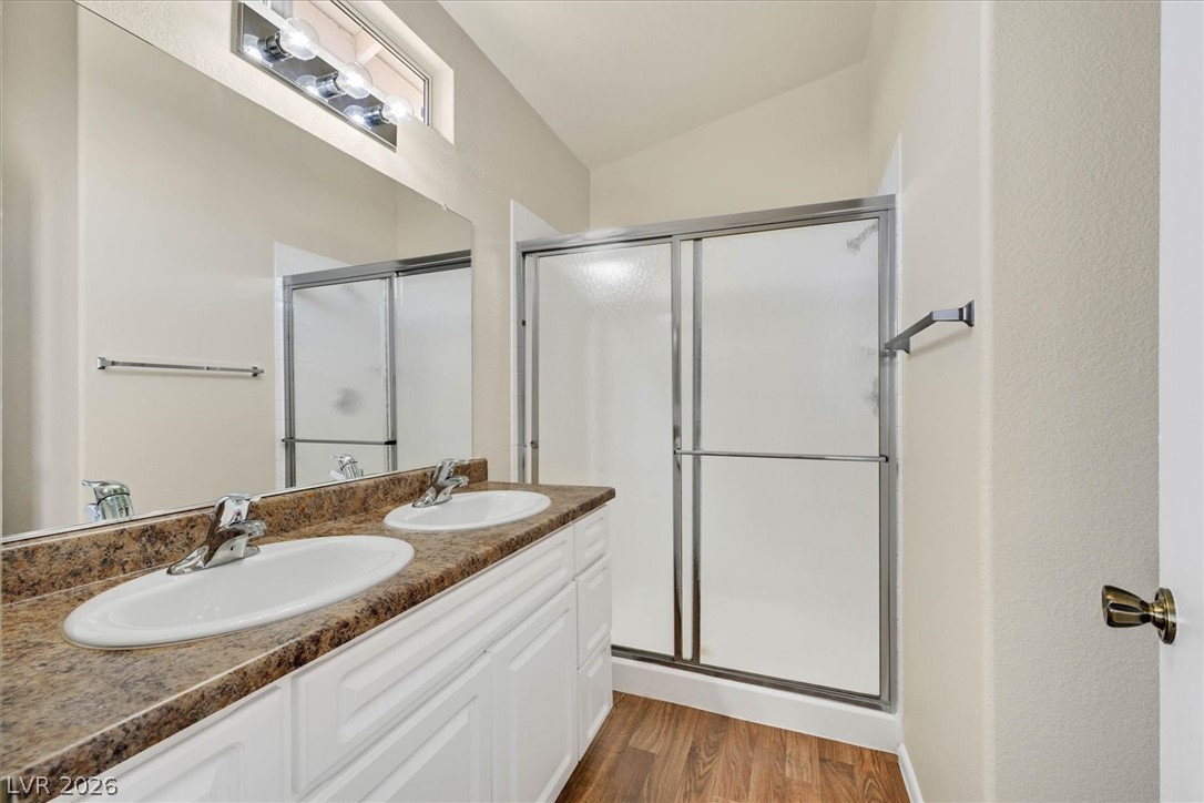 330 Warm Front Street Henderson, NV 89014 - Photo 16 of 25 This bathroom offers dual vanities, a spacious mirrored wall, and a convenient shower.