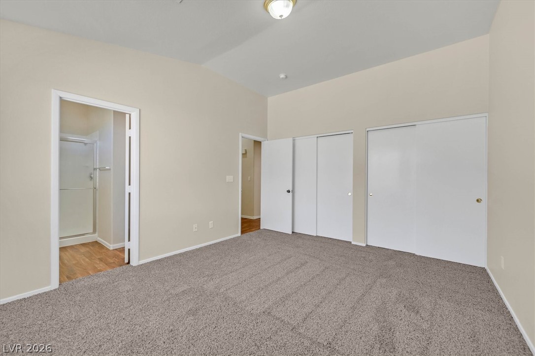 330 Warm Front Street Henderson, NV 89014 - Photo 19 of 25 This spacious bedroom offers ample natural light and direct access to a private bathroom.
