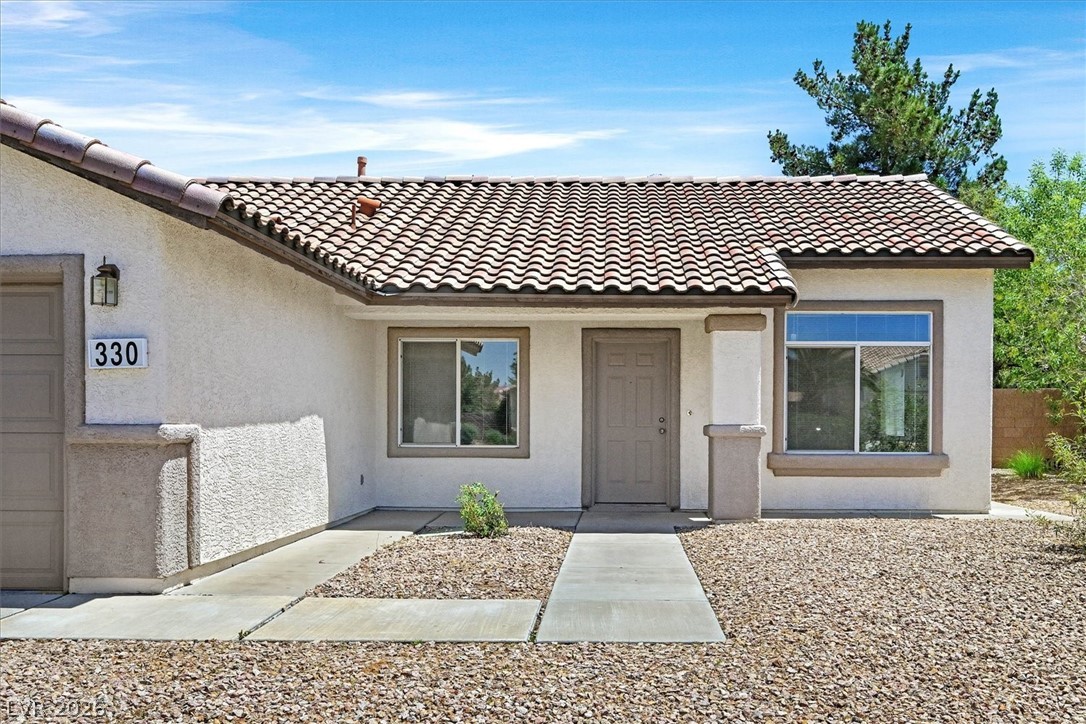 330 Warm Front Street Henderson, NV 89014 - Photo 2 of 25 A welcoming facade with a classic tile roof, set against a clear blue sky.