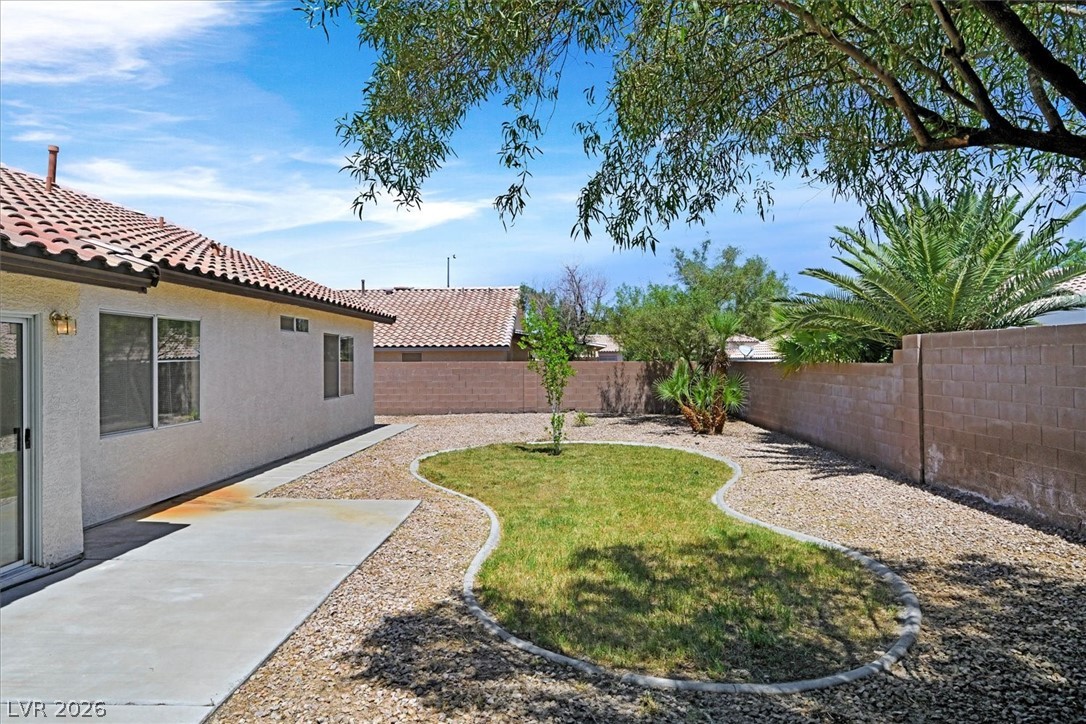 330 Warm Front Street Henderson, NV 89014 - Photo 22 of 25 This spacious private yard features a vibrant lawn, lush landscaping, and a convenient patio area.