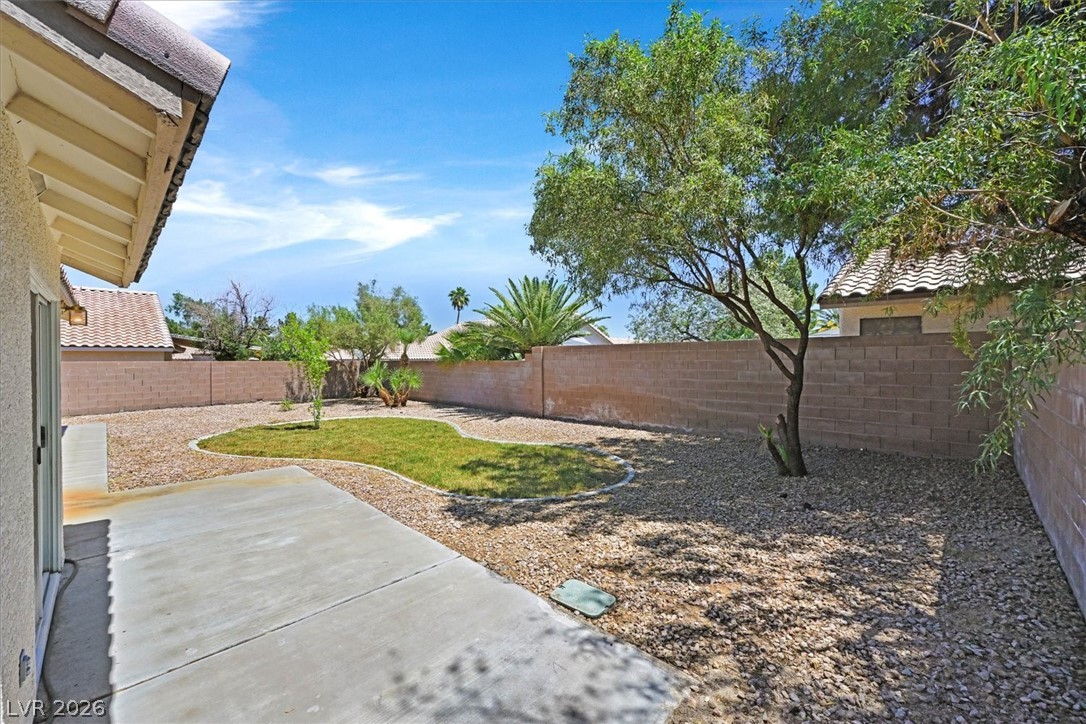 330 Warm Front Street Henderson, NV 89014 - Photo 25 of 25 Relax in the private yard featuring a patio, lush lawn, and mature trees.