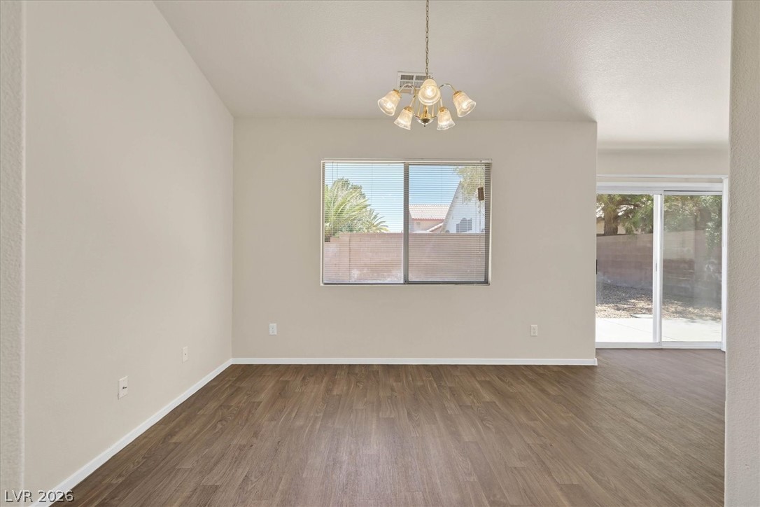 330 Warm Front Street Henderson, NV 89014 - Photo 7 of 25 This bright space offers rich wood flooring and a classic chandelier, ideal for daily living.