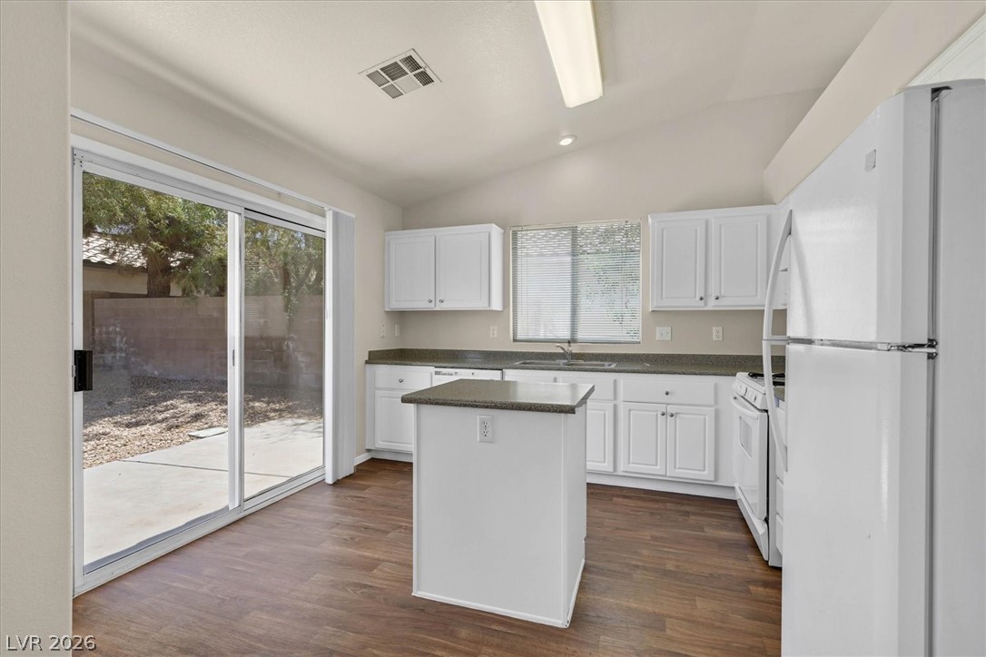 330 Warm Front Street Henderson, NV 89014 - Photo 8 of 25 This bright kitchen features ample counter space, a central island, and convenient patio access.