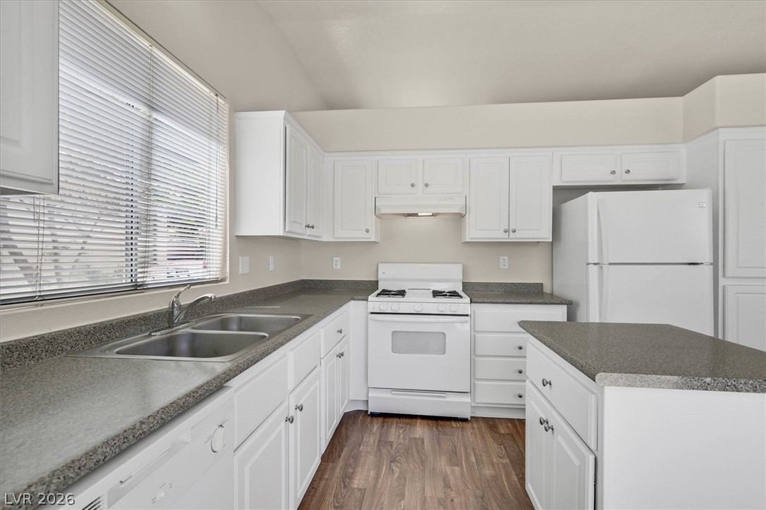 330 Warm Front Street Henderson, NV 89014 - Photo 9 of 25 This spacious kitchen offers white cabinetry, ample counter space, and modern appliances for daily living.