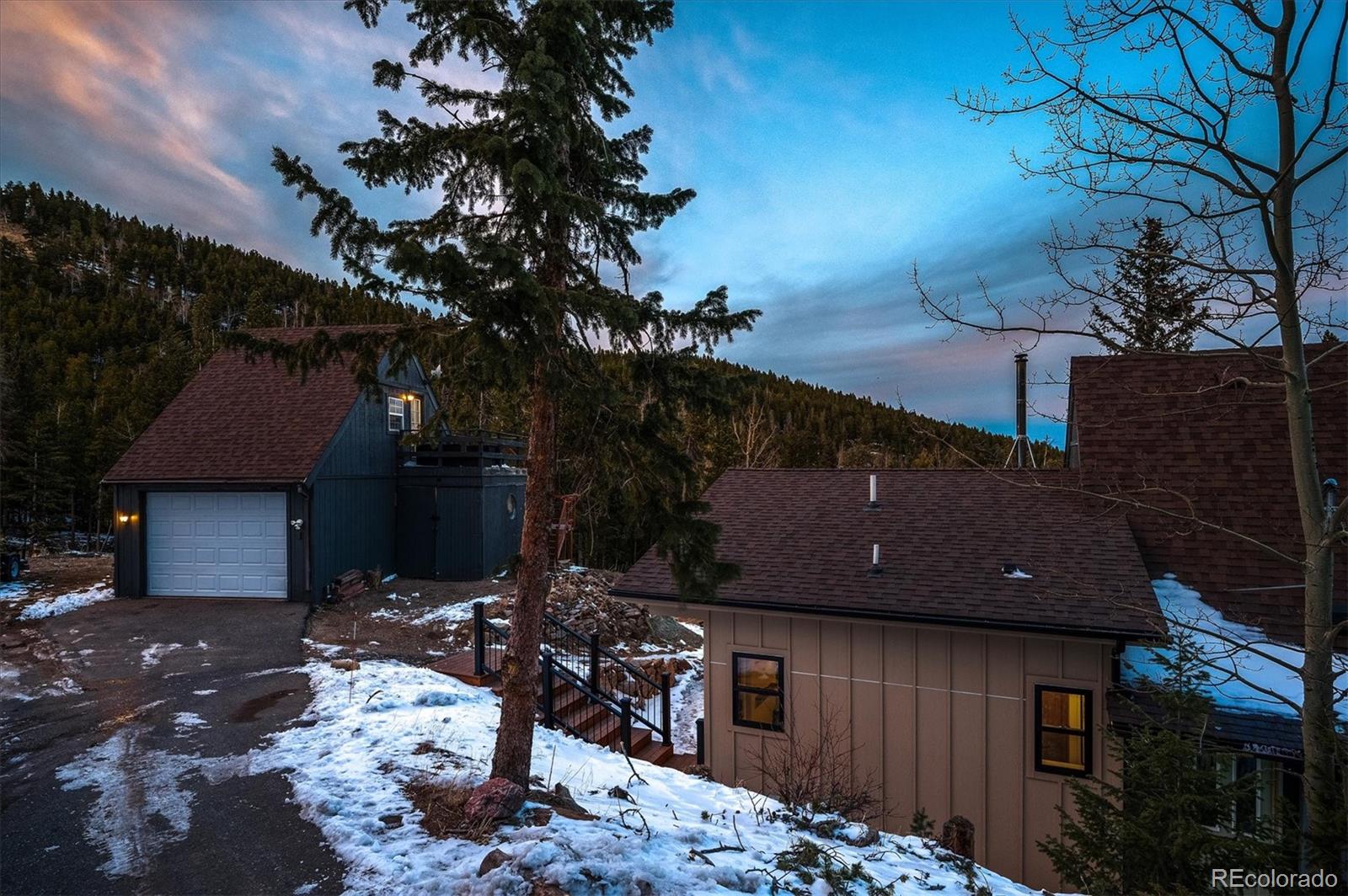 1633 Sinton Road Evergreen, CO 80439 - Photo 35 of 39 a side view of a house with a yard