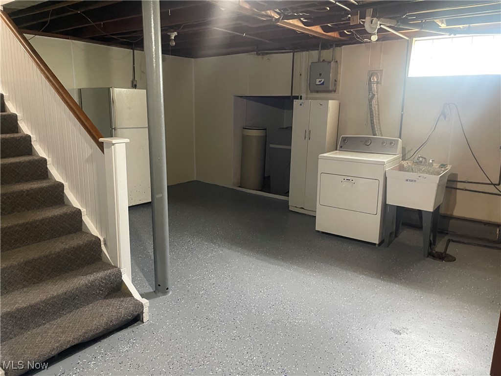 1624 Krumroy Road Akron, OH 44306 - Photo 35 of 47 Below grade area featuring dryer, stairway, electric panel, and freestanding refrigerator