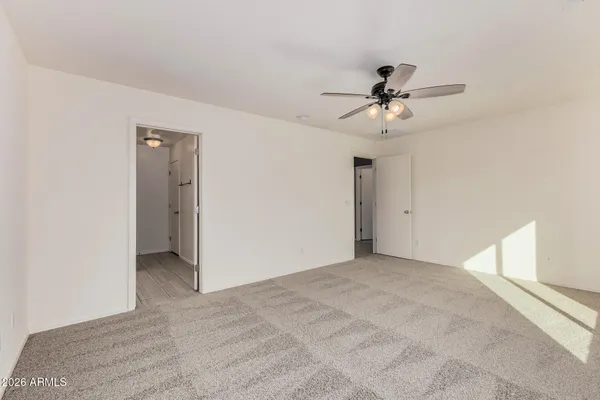 a view of a room with a ceiling fan and a window