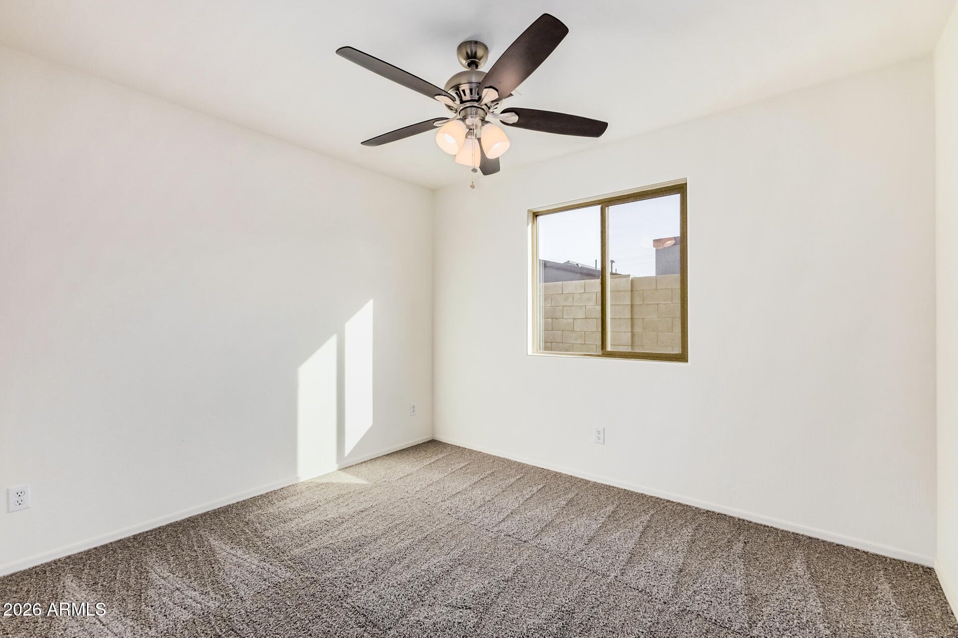 1877 West Rd Agent Street Apache Junction, AZ 85120 - Photo 16 of 24 an empty room with windows and fan