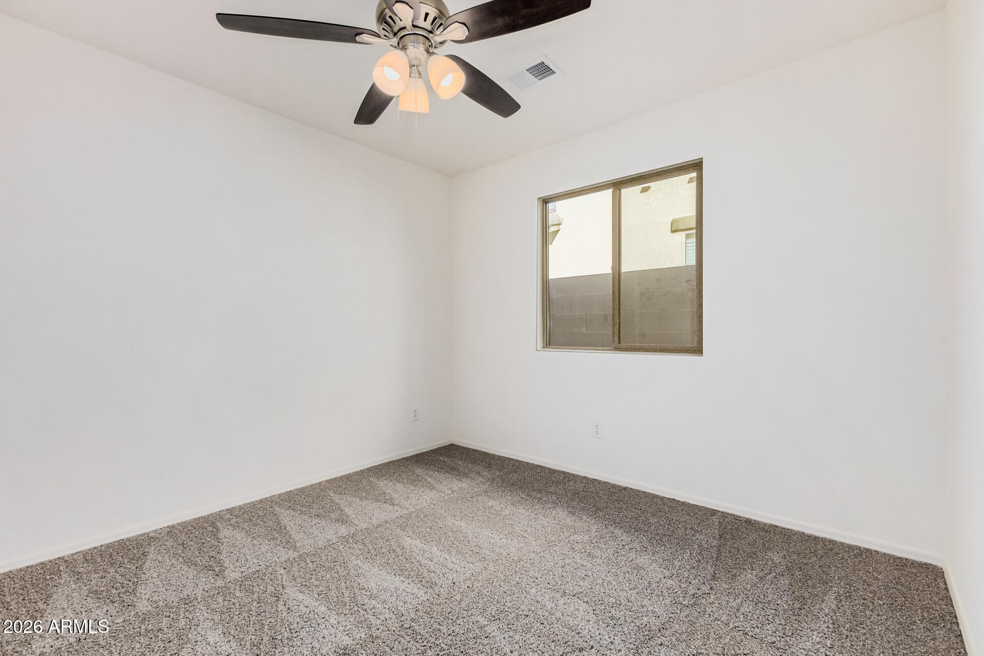 1877 West Rd Agent Street Apache Junction, AZ 85120 - Photo 18 of 24 an empty room with a window and a fan