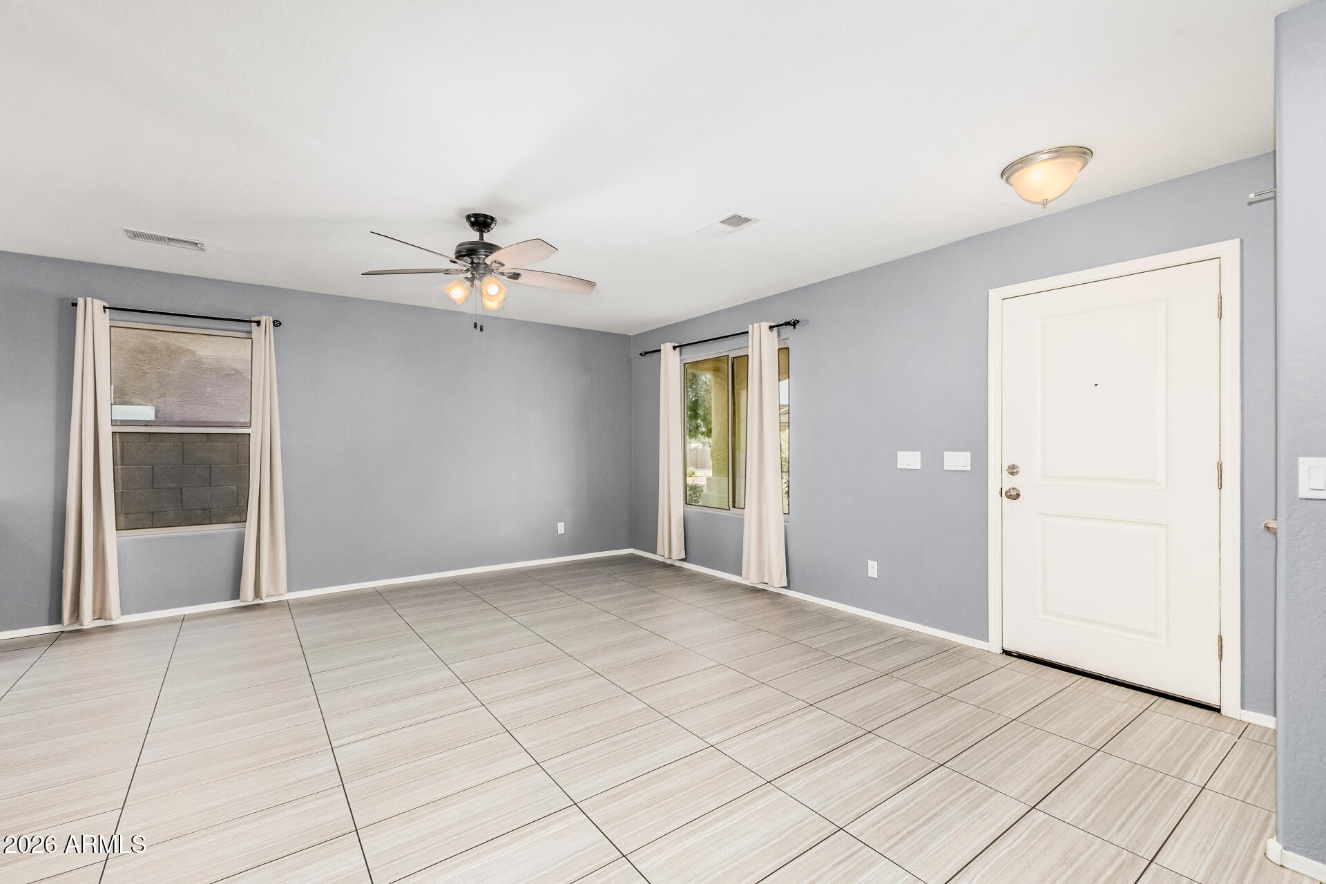 1877 West Rd Agent Street Apache Junction, AZ 85120 - Photo 4 of 24 an empty room with fan and windows