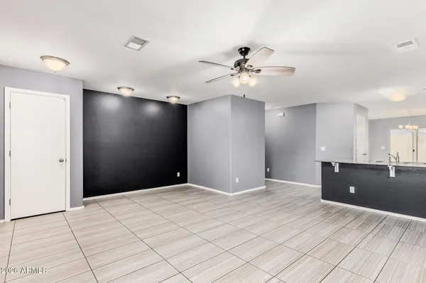 a view of an empty room with a ceiling fan