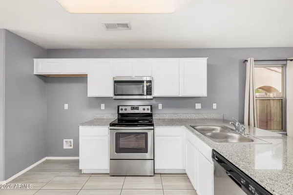 a kitchen with a sink stove and microwave