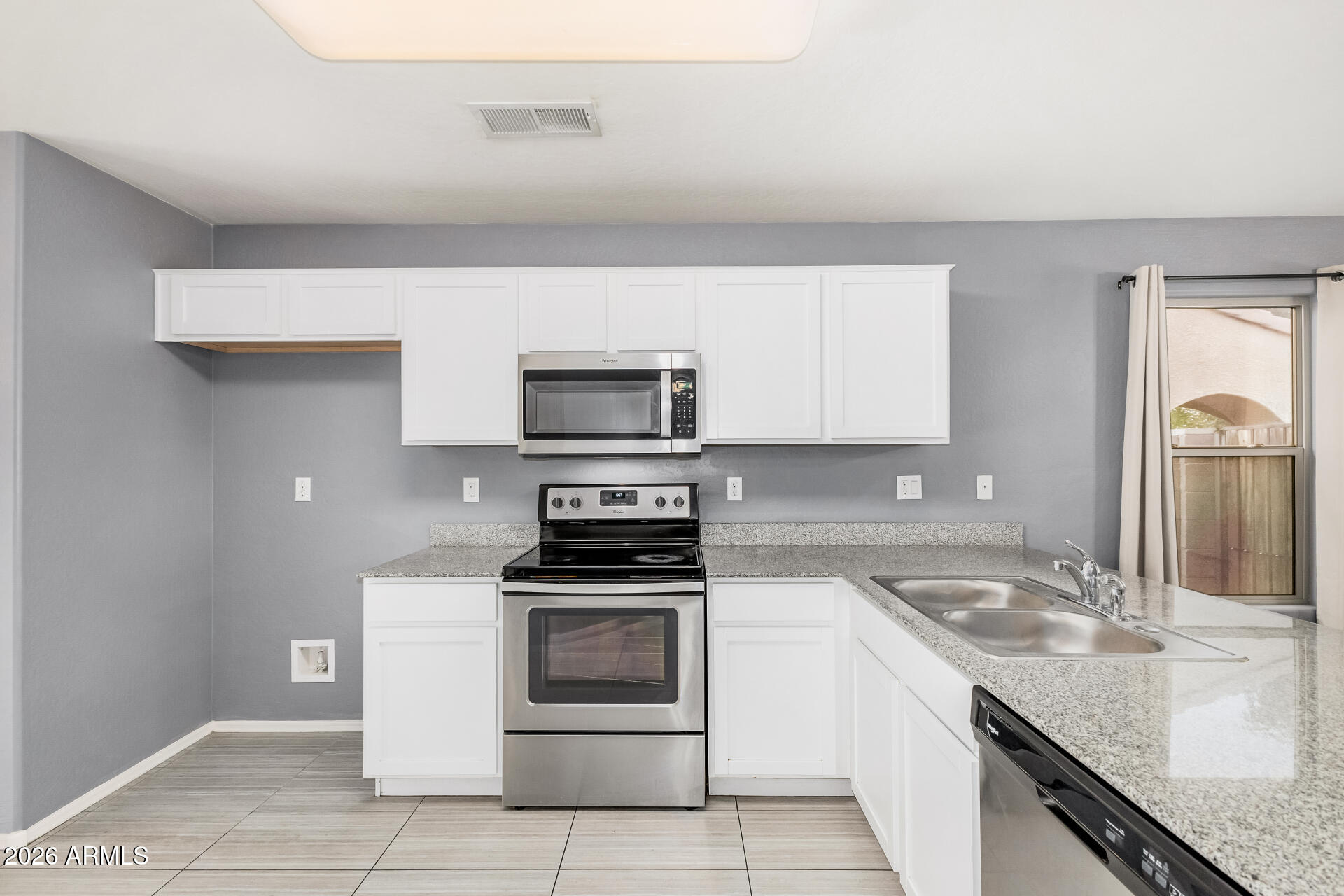 1877 West Rd Agent Street Apache Junction, AZ 85120 - Photo 9 of 24 a kitchen with a sink stove and microwave