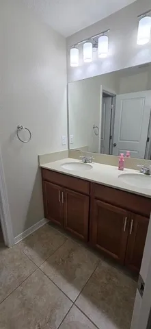 a bathroom with a sink vanity and mirror