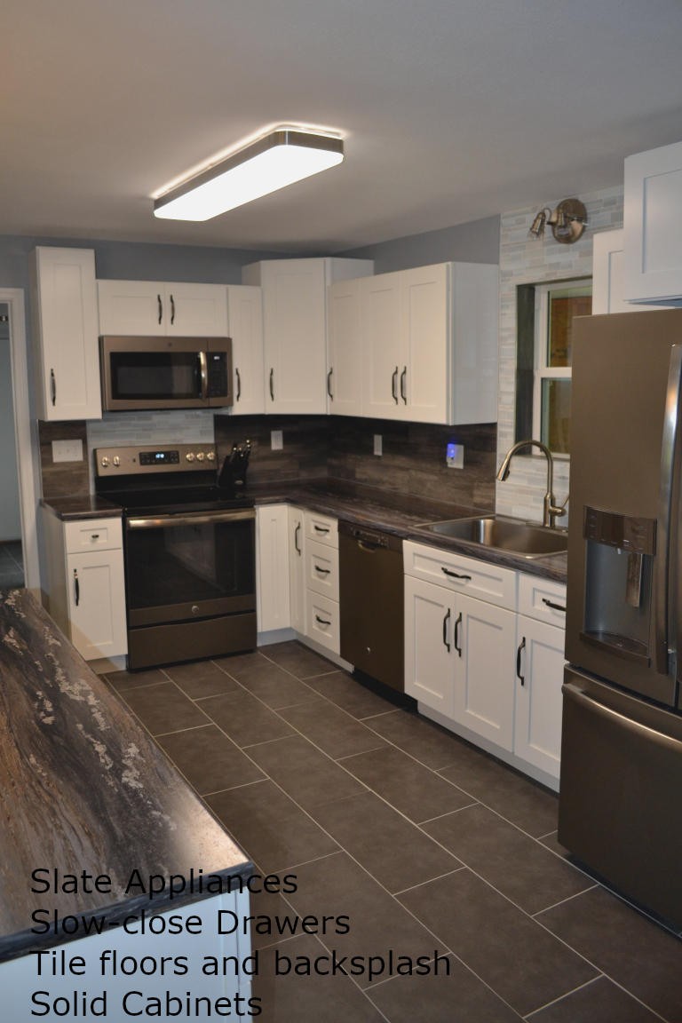 1481 Dutch Valley Road Clinton, TN 37716 - Photo 7 of 24 a kitchen with stainless steel appliances a stove sink and microwave