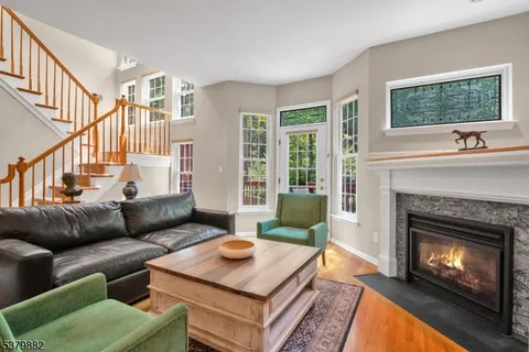 a living room with furniture a fireplace and a window