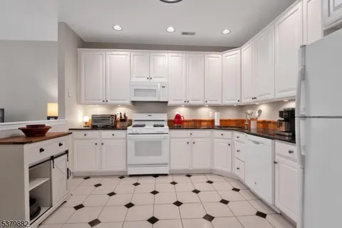 a kitchen with stainless steel appliances a refrigerator sink and cabinets