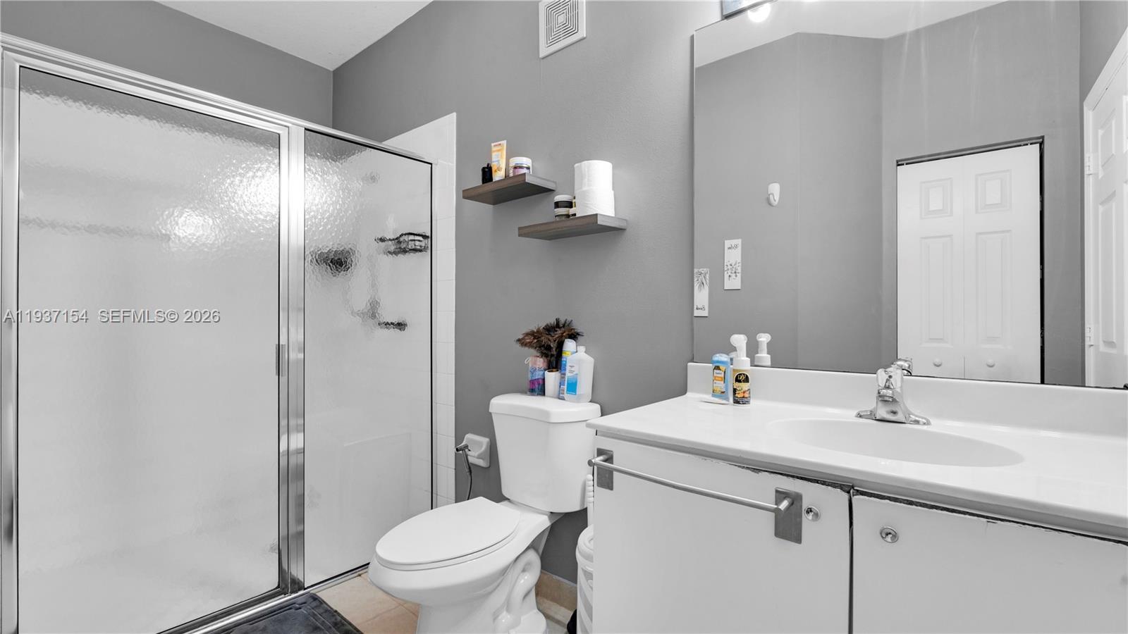 13103 Southwest 42nd Street, Unit 5106 Miramar, FL 33027 - Photo 27 of 35 a bathroom with a sink toilet and shower