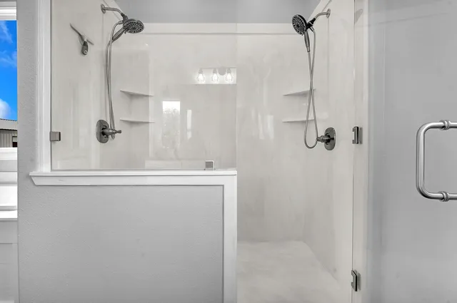 a bathroom with a shower and a sink