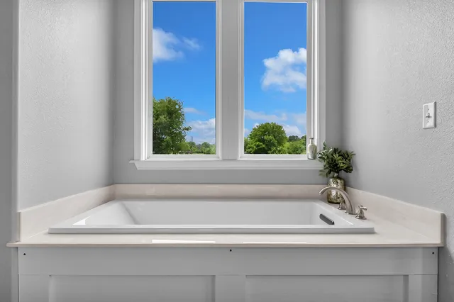 a white bath tub sitting next to a white sink