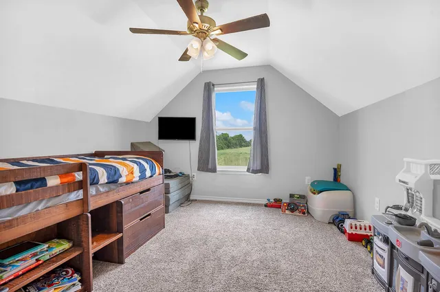 a bedroom with bed and a window