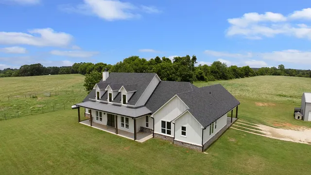 a view of a house with a yard and sitting area