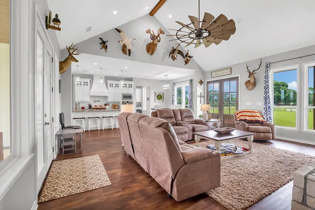 a living room with furniture ceiling fan and a rug