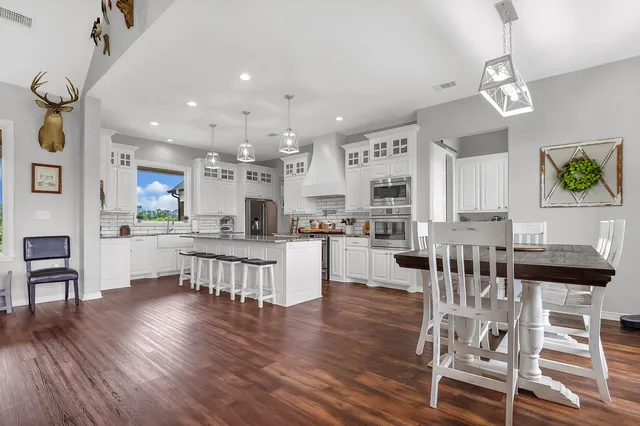 a living room with kitchen island furniture and a wooden floor