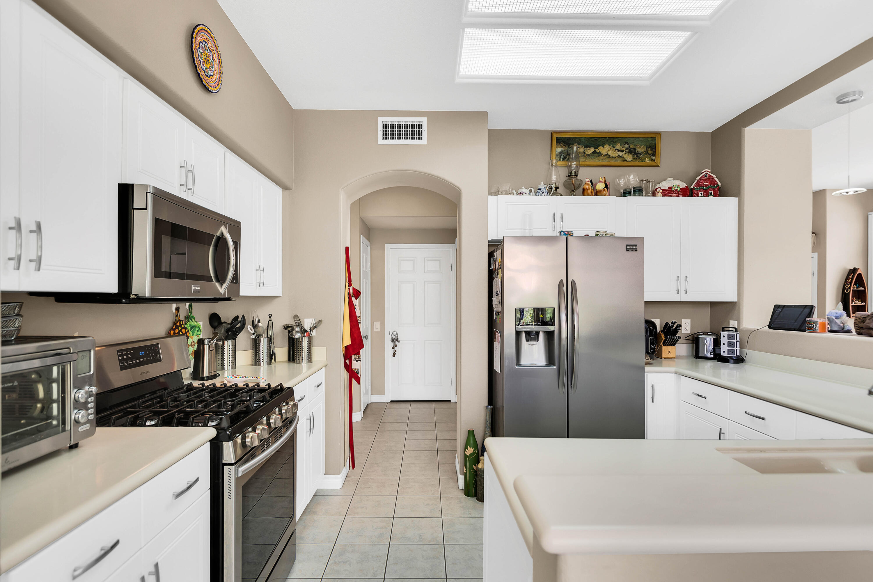 78386 Moongold Road Palm Desert, CA 92211 - Photo 17 of 43 a kitchen with stainless steel appliances granite countertop a refrigerator a stove top oven a sink and dishwasher