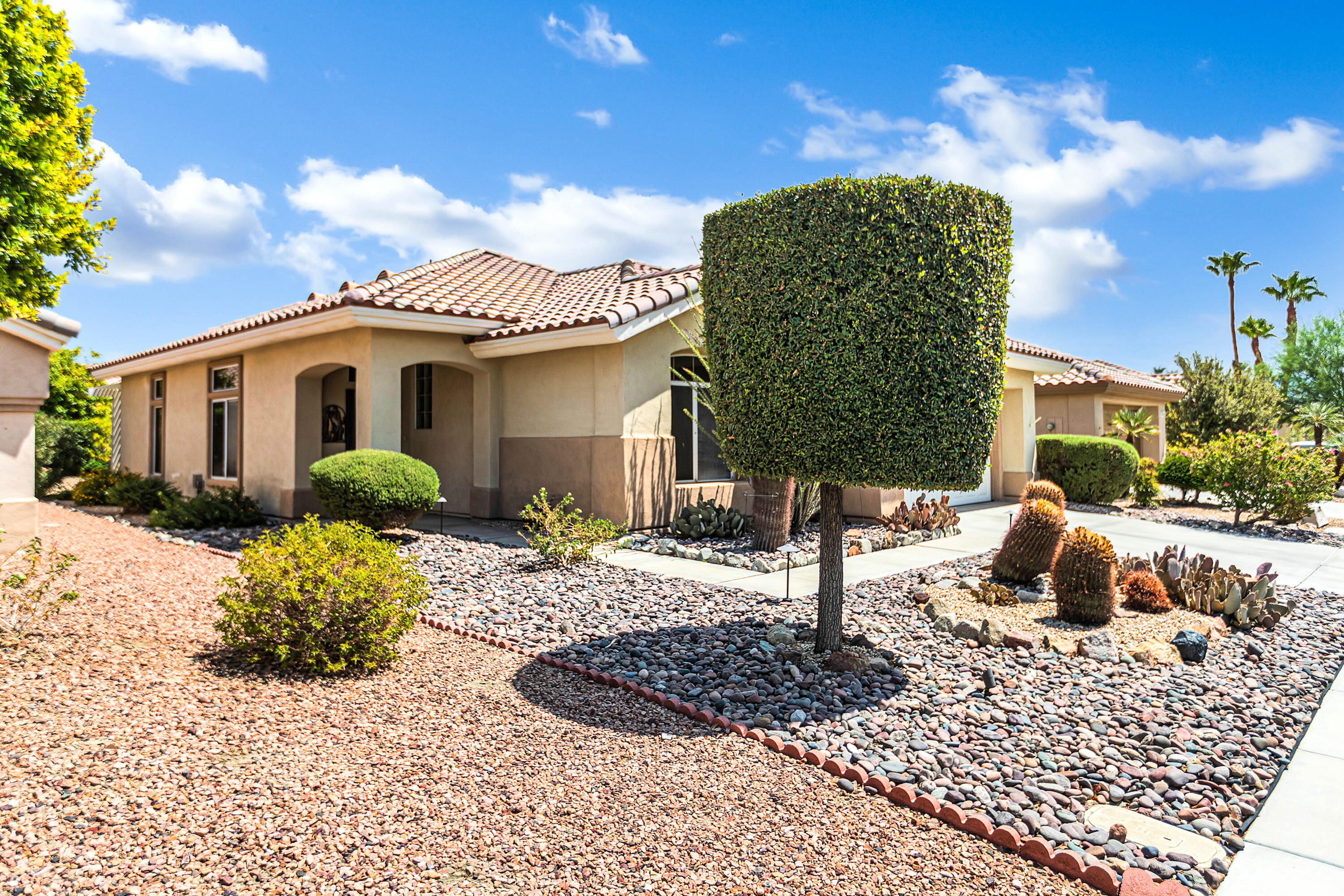78386 Moongold Road Palm Desert, CA 92211 - Photo 3 of 43 a front view of a house with a yard