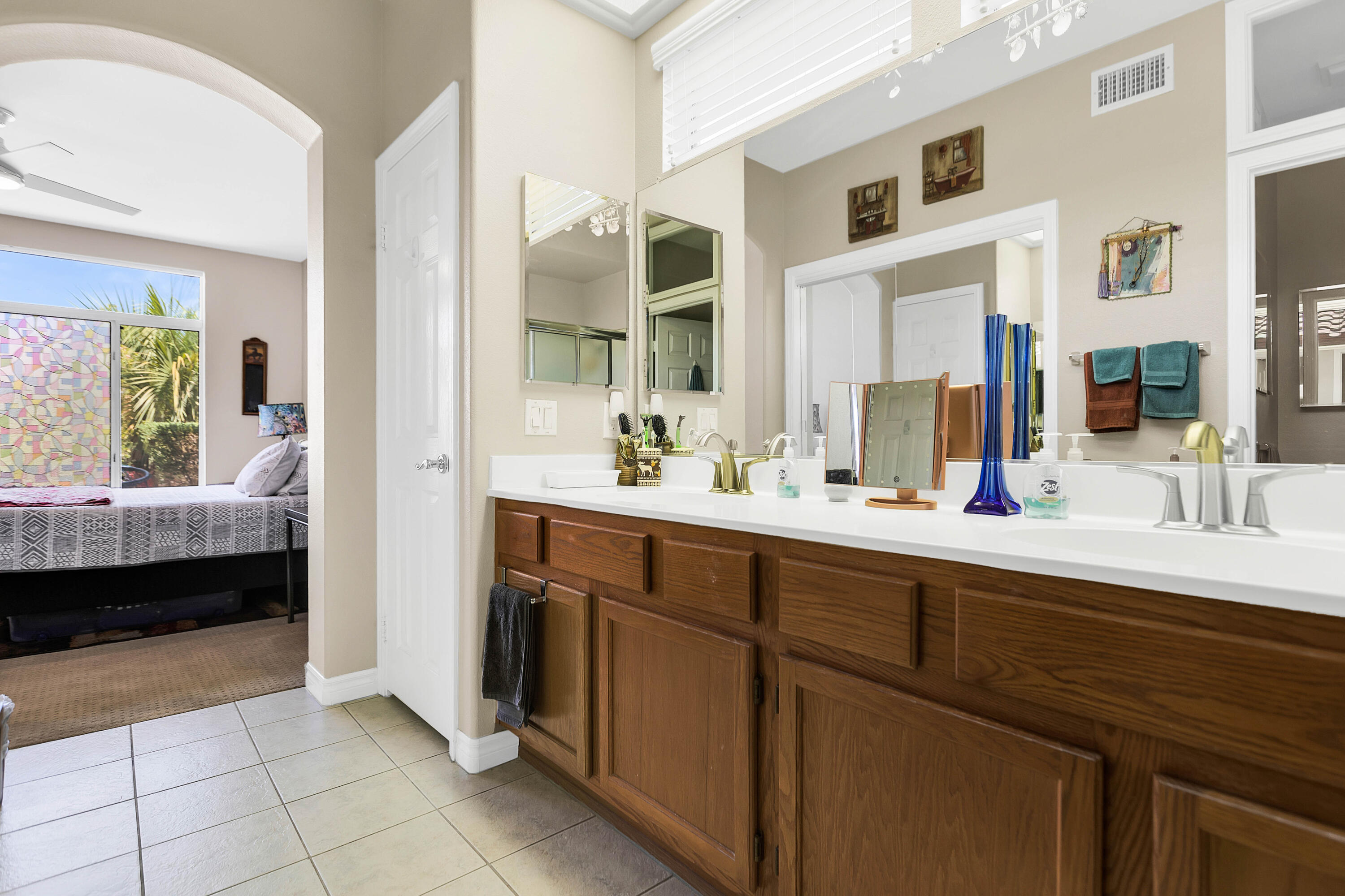 78386 Moongold Road Palm Desert, CA 92211 - Photo 33 of 43 a en suite bathroom with a double vanity sink a mirror and a shower