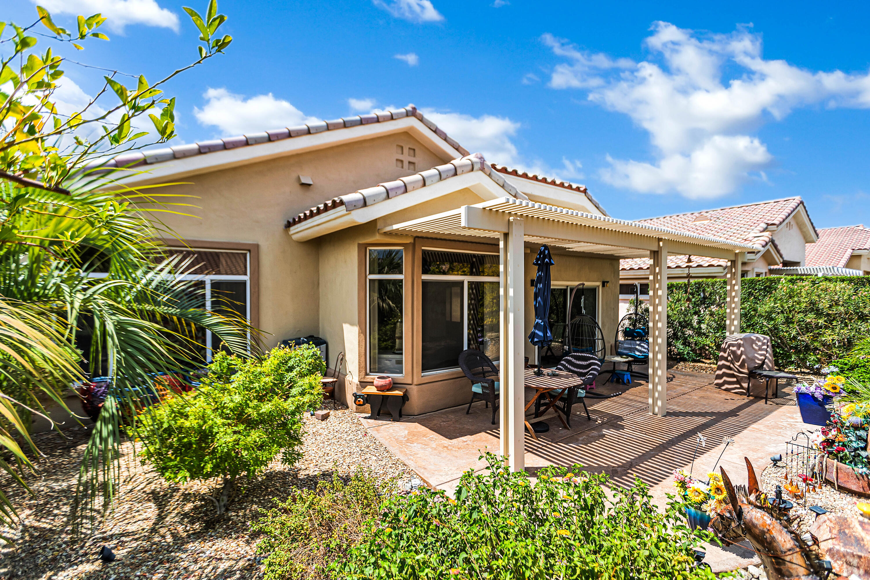 78386 Moongold Road Palm Desert, CA 92211 - Photo 5 of 43 a view of a patio with table and chairs under an umbrella
